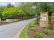 Scenic community entrance with lush landscaping, stone signage, and well-maintained street at 1564 Brunswick St, Lithia Springs, GA 30122
