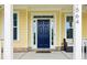 Elegant blue front door framed by sidelights and a covered porch at 1564 Brunswick St, Lithia Springs, GA 30122