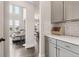 Hallway view showcases light gray walls, modern cabinets, and access to a brightly lit living area at 1564 Brunswick St, Lithia Springs, GA 30122