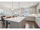 Modern kitchen with a large island, stainless steel appliances, and gray cabinets, perfect for cooking and entertaining at 1564 Brunswick St, Lithia Springs, GA 30122