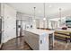 Gray cabinets, stainless steel appliances, large island, and wood floors for a modern kitchen design at 1564 Brunswick St, Lithia Springs, GA 30122