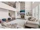 Inviting living room showcasing a stone fireplace, built-in bookshelves, and an open staircase to the upper level at 1564 Brunswick St, Lithia Springs, GA 30122