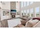 Bright living room with a stone fireplace, built-in shelves, and soaring windows offering scenic views at 1564 Brunswick St, Lithia Springs, GA 30122
