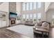 Bright living room with a stone fireplace, built-in shelves, and soaring windows offering scenic views at 1564 Brunswick St, Lithia Springs, GA 30122