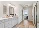 Bright main bathroom featuring a shower, soaking tub and double sink at 1564 Brunswick St, Lithia Springs, GA 30122