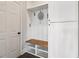 Mudroom features storage with a built-in bench, hooks, and shelves near an exterior door at 1564 Brunswick St, Lithia Springs, GA 30122