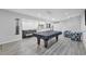 Basement rec room features a pool table, couches, chairs, and modern lighting for entertainment at 1840 Tululah Trl, Smyrna, GA 30082