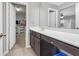Bathroom with a long white countertop and a door leading to a walk-in closet and an adjacent bedroom at 1840 Tululah Trl, Smyrna, GA 30082
