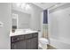 Cozy bathroom featuring a shower-tub combo with a patterned curtain, a modern vanity, and neutral tones at 1840 Tululah Trl, Smyrna, GA 30082