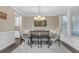 Formal dining room with stylish decor, featuring a modern chandelier and wainscoting at 1840 Tululah Trl, Smyrna, GA 30082