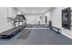 Modern home gym with large mirror, treadmill, and workout equipment on a blue padded floor at 1840 Tululah Trl, Smyrna, GA 30082