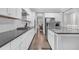 Spacious kitchen features stainless steel appliances, white cabinets, gray countertops, and hardwood floors at 1840 Tululah Trl, Smyrna, GA 30082