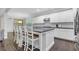 Bright kitchen boasts white cabinets, stainless appliances, and a spacious island with barstool seating at 1840 Tululah Trl, Smyrna, GA 30082