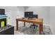 Home office featuring a wooden desk with computer, a gray rug, and a comfortable desk chair at 1840 Tululah Trl, Smyrna, GA 30082