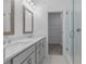 Modern bathroom with double sinks, walk-in shower, and a view of the walk-in closet at 344 Olmstead Way # 32, Alpharetta, GA 30022