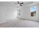 Bright bedroom with carpet, ceiling fan and trey ceiling with natural light from the windows at 344 Olmstead Way # 32, Alpharetta, GA 30022