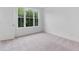 Bright bedroom with carpet, featuring a large window and neutral tones at 344 Olmstead Way # 32, Alpharetta, GA 30022