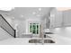 Kitchen with white cabinets, modern appliances, and a view of the staircase and backyard at 344 Olmstead Way # 32, Alpharetta, GA 30022