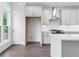 Bright kitchen features white cabinets, stainless steel appliances, and hardwood floors at 344 Olmstead Way # 32, Alpharetta, GA 30022