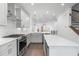 Modern kitchen boasts white cabinets, stainless steel appliances, and a central island at 344 Olmstead Way # 32, Alpharetta, GA 30022