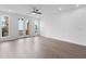 Bright living room with hardwood floors, ceiling fan, and natural light from the windows and french doors at 344 Olmstead Way # 32, Alpharetta, GA 30022