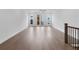 Open concept living room featuring hardwood floors, white walls, and access to outdoor balcony at 344 Olmstead Way # 32, Alpharetta, GA 30022