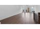 Living room featuring hardwood floors, white walls, and a door to an outdoor balcony at 344 Olmstead Way # 32, Alpharetta, GA 30022