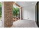Covered patio area with brick flooring, offering a serene outdoor space with views of lush greenery at 344 Olmstead Way # 32, Alpharetta, GA 30022