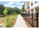 Scenic walking path beside lush greenery and a tranquil pond, offering a peaceful outdoor experience at 344 Olmstead Way # 32, Alpharetta, GA 30022