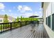 A spacious wooden back deck with seating, a table, and an umbrella is perfect for outdoor living at 4425 Martel Dr, Cumming, GA 30040