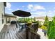 Outdoor deck with table and chairs, surrounded by greenery and a clear blue sky, ideal for relaxation at 4425 Martel Dr, Cumming, GA 30040