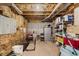 Unfinished basement with exposed beams, storage shelves, and some stored items at 4425 Martel Dr, Cumming, GA 30040