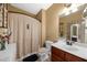 Bathroom with single sink, toilet, shower, and curtain at 4425 Martel Dr, Cumming, GA 30040