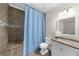 Bathroom with a single vanity sink, shower with a blue curtain, and neutral accents at 4425 Martel Dr, Cumming, GA 30040