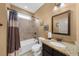 Clean bathroom with granite countertop, tiled shower, and neutral color scheme at 4425 Martel Dr, Cumming, GA 30040