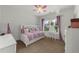 Bright bedroom features a white daybed with a built-in bookcase and a matching vanity set at 4425 Martel Dr, Cumming, GA 30040