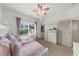 This bedroom boasts a cozy daybed with a matching vanity and a ceiling fan at 4425 Martel Dr, Cumming, GA 30040