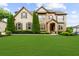 Charming two-story home with stone accents, manicured lawn, and tasteful landscaping at 4425 Martel Dr, Cumming, GA 30040