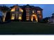 Charming two-story home with stone accents and tasteful landscaping at dusk at 4425 Martel Dr, Cumming, GA 30040