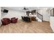 Open game room with bar area featuring wood floors, ceiling fan, and TV at 4425 Martel Dr, Cumming, GA 30040