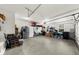 Two car garage with concrete flooring and an additional refrigerator and storage at 4425 Martel Dr, Cumming, GA 30040
