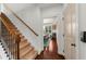 Hallway with staircase leading to a cozy breakfast nook, blending function and style seamlessly at 4425 Martel Dr, Cumming, GA 30040