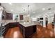 Bright kitchen with granite counters, stainless appliances, and hardwood floors opens to the living room at 4425 Martel Dr, Cumming, GA 30040