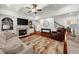 Spacious living room with fireplace, built-ins, hardwood floors, and view to kitchen at 4425 Martel Dr, Cumming, GA 30040