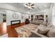 Open concept living room with hardwood floors, comfortable seating, and view to kitchen at 4425 Martel Dr, Cumming, GA 30040