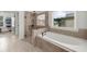 The main bathroom features a glass-enclosed shower and a soaking tub by a sunny window at 4425 Martel Dr, Cumming, GA 30040