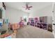 Spacious playroom with a ceiling fan, window, ample room for activities and toy storage at 4425 Martel Dr, Cumming, GA 30040