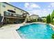 Backyard pool featuring a covered patio, outdoor seating, and meticulously maintained landscaping at 4425 Martel Dr, Cumming, GA 30040