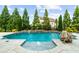 Sparkling in-ground pool with stone accents, lush landscaping, and tranquil fountains at 4425 Martel Dr, Cumming, GA 30040