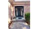 Inviting front entrance with decorative lanterns and charming dog statues at 6340 Koweta Rd, Fairburn, GA 30213